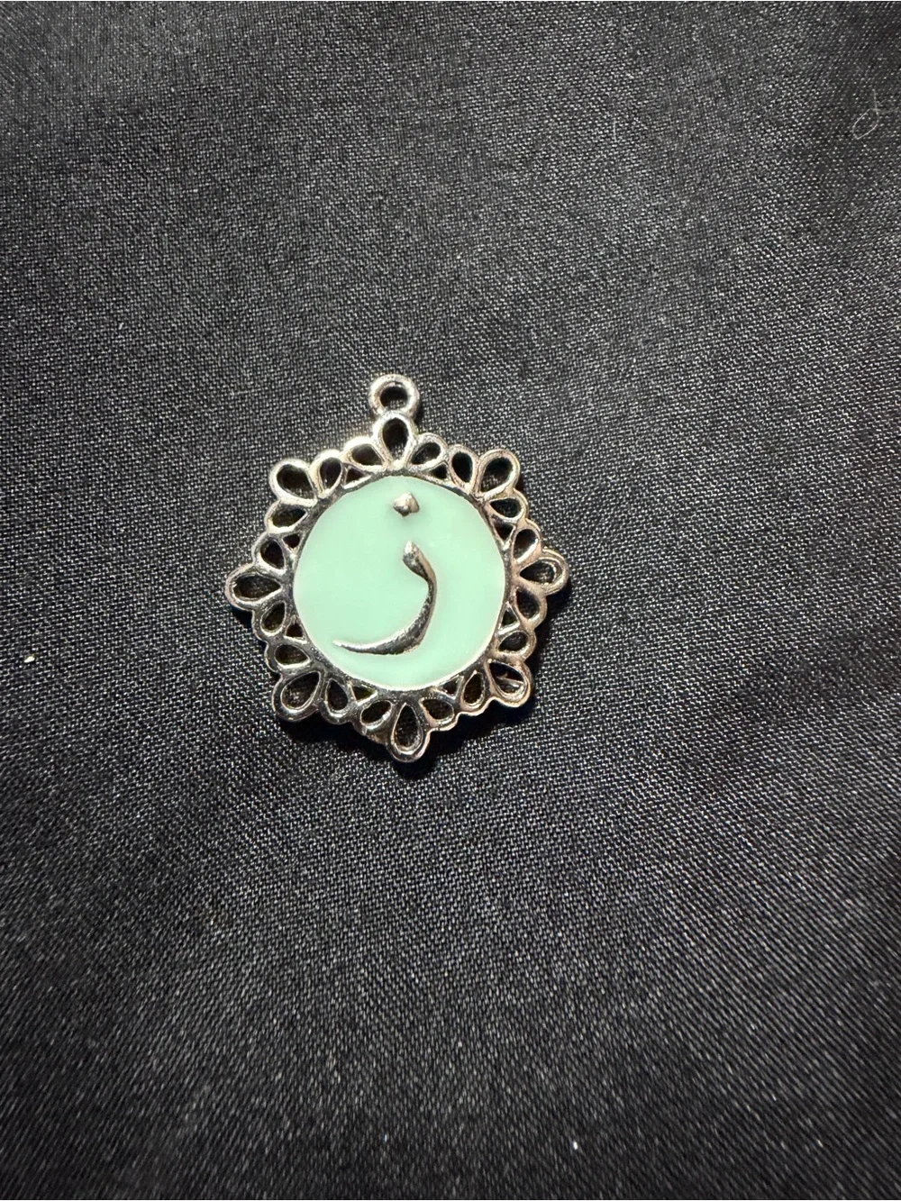 silver-finished pendant featuring a mint-green enamel center with the Arabic